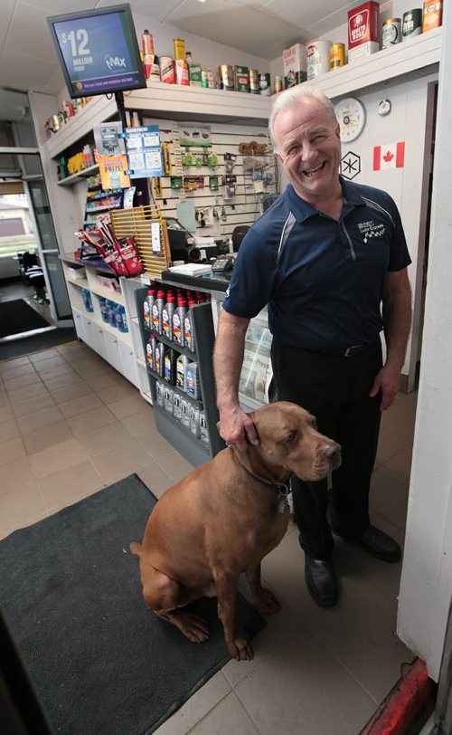 PHIL HOSSACK / WINNIPEG FREE PRESS -  Jeff Kendel and his pooch Mike Jones pose in front of the signless canopy at his corner gas and service station at McLeod and Molsen Tuesday. See Kelly Taylor feature. May 10, 2016