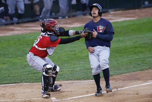 JOHN WOODS / WINNIPEG FREE PRESS Winnipeg Goldeyes' Carlton Tanabe (28) is tagged out as he attempts to make it home against Fargo Moorehead Redhawks' Charlie Valerio (15) in Winnipeg Tuesday, May 10, 2016.
