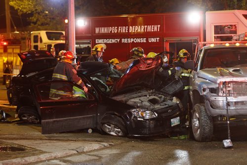 JOHN WOODS / WINNIPEG FREE PRESS Emergency crews work to extricate the occupant of a vehicle involved in a mvc at Watt and Munroe in Winnipeg Tuesday, May 10, 2016.