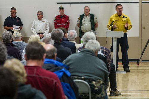 MIKE DEAL / WINNIPEG FREE PRESS Geoff Smith a Conservation Officer with Manitoba Sustainable Development talks to area residents who gathered at the Whitehall Community Hall in Falcon Lake for an information meeting put together by Manitoba and Ontario fire officials for those affected by the Caddy Lake fire Thursday evening. 160512 - Thursday, May 12, 2016