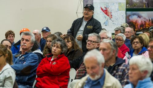 MIKE DEAL / WINNIPEG FREE PRESS Bob Hazlehurst who has a cabin in Ingolf, Ont. asks a question during an information meeting put together by Manitoba and Ontario fire officials for those affected by the Caddy Lake fire at the Whitehall Community Hall in Falcon Lake Thursday evening. 160512 - Thursday, May 12, 2016