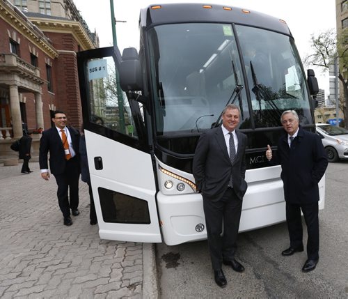 WAYNE GLOWACKI / WINNIPEG FREE PRESS   Paul Soubry, New Flyer president and CEO with Brian Tobin,Chairman of the Board at right pose for a picture before boarding a MCI bus outside the Manitoba Club Friday with Bay Street analysts for a tour the plants.  Martin Cash  story  May 13  2016