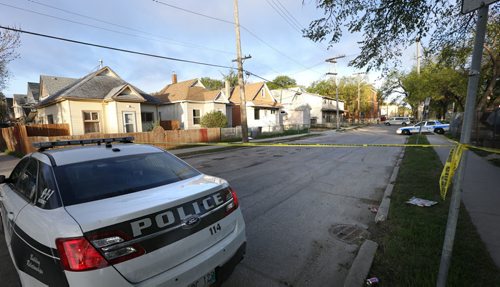 WAYNE GLOWACKI / WINNIPEG FREE PRESS   Winnipeg Police and Cadets secure a crime scene on a  section on Wellington Ave. between Agnes St.  and Victor St. Friday morning.  May 13  2016