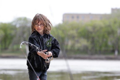 RUTH BONNEVILLE / WINNIPEG FREE PRESS  Nine-year-old Cade Cameron gets ready to cast his line along the banks of the Assiniboine River at the junction of the Red at the Forks on the opening day of the start of the fishing season in Manitoba Saturday.  His dad Cory Cameron hadn't caught anything yet but enjoy spending the day fishing together. Standup photo.   May 14, , 2016