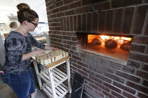 JOHN WOODS / WINNIPEG FREE PRESS Suzanne Gessler, owner of Pennyloaf Bakery on Corydon attends to some morning rolls Sunday, May 15, 2016.