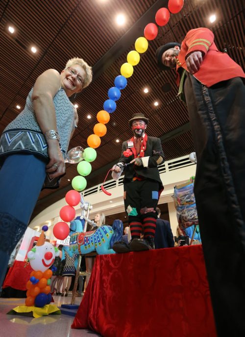 JASON HALSTEAD / WINNIPEG FREE PRESS  Denise Friesen has some fun with clowns performing at the carnival-themed Come One, Come All Gold Heart Gala fundraiser for Variety, the Childrens Charity of Manitoba, at the Club Regent Event Centre on May 7, 2016. (For Social Page)