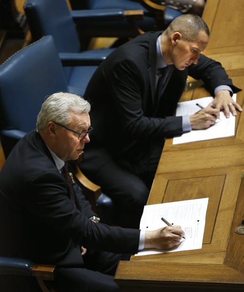 WAYNE GLOWACKI / WINNIPEG FREE PRESS     At left, former Premier Greg Selinger and Kevin Chief take notes in the Manitoba Legislature Monday during  the reading of the Throne Speech. ¤Nick Martin / Kristin Annable  stories May 16  2016