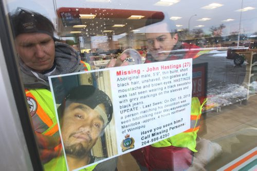 JOE BRYKSA / WINNIPEG FREE PRESS  Bear Clan Patrol on patrol in Winnipegs North End  Clan members place missing poster in window on Salter Ave 7-11., March 17  , 2016.(see  Alex Paul story)