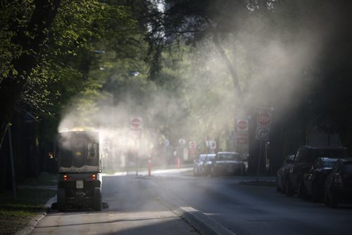 JOHN WOODS / WINNIPEG FREE PRESS A street cleaner makes its way down Assiniboine Avenue Monday, May 9, 2016.