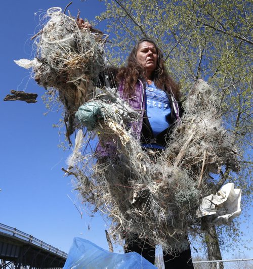 WAYNE GLOWACKI / WINNIPEG FREE PRESS    Cindy Kovach with discarded fishing line and hooks she has found on the shore along the east side of the Red River north of the St. Andrews Lock and Dam this spring.This is the contents of one of the four large bags collected out of concern for the safety of the birds.  Ashley Prest story May 17  2016