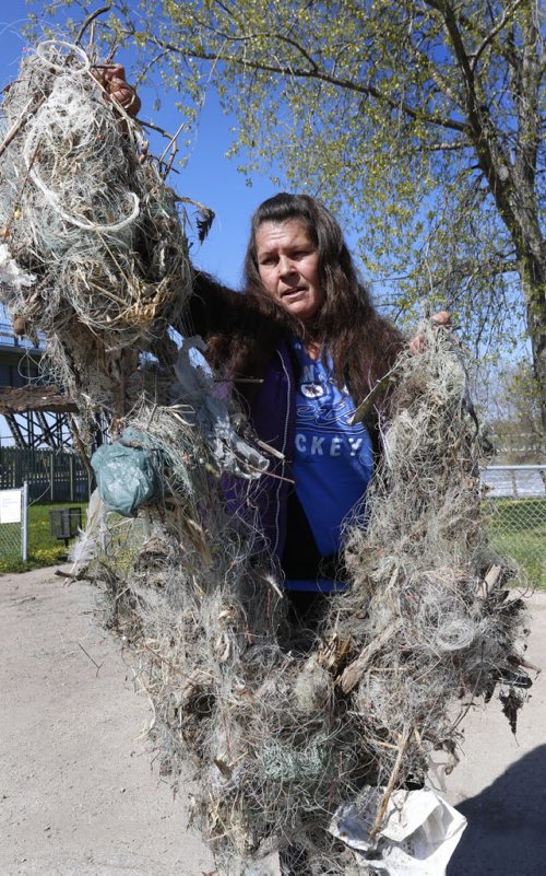 WAYNE GLOWACKI / WINNIPEG FREE PRESS    Cindy Kovach with discarded fishing line and hooks she has found on the shore along the east side of the Red River north of the St. Andrews Lock and Dam this spring. This is the contents of one of the four large bags collected out of concern for the safety of the birds.  Ashley Prest story May 17  2016