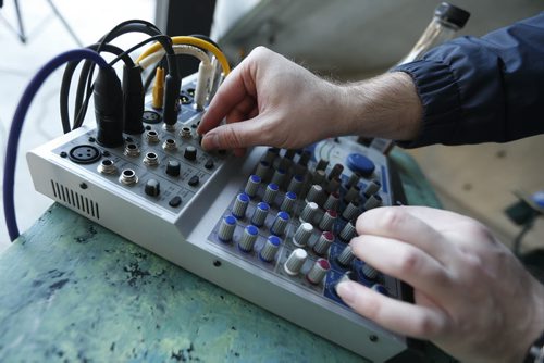 JOHN WOODS / WINNIPEG FREE PRESS Paul Little works the soundboard at Caravan, an open mic event at Old Market Square, Monday, May 16, 2016.
