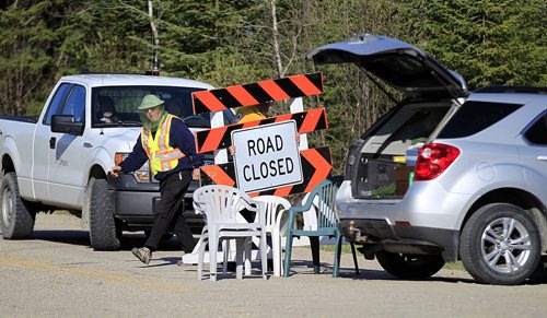 PHIL HOSSACK / WINNIPEG FREE PRESS -  Ontario Ministry of Natural Resourses and Forestry along with Manitba Sustainable Development employess pack up a road block that was restricting access to Caddy Lake's East Shore cottagers and Ingolf Tuesday afternoon allowing full public access to the area. See Alex Paul story.  May 16, 2016