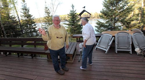 PHIL HOSSACK / WINNIPEG FREE PRESS -  Hardy and Elke May check out their Caddy Lake cottage after returning Tuesday, the only evidence they found was a broken piece of a sprinkler the local fire department had already taken down from their rooftop.  See Alex Paul story.  May 16, 2016