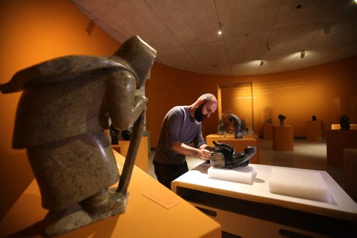 RUTH BONNEVILLE / WINNIPEG FREE PRESS  Radovan Radulovic, WAG Head of Conservation, sets up Winnipeg Art Gallery's new exhibition by inuit artist - Oviloo Tunnillie,  A Woman's Story in Stone, and involves 67 stone carvings.  Stone carving on left - Ikayukta Tunnillie Carrying Her Drawings to the Co-op, 1997 serpentinite.    May 18, , 2016