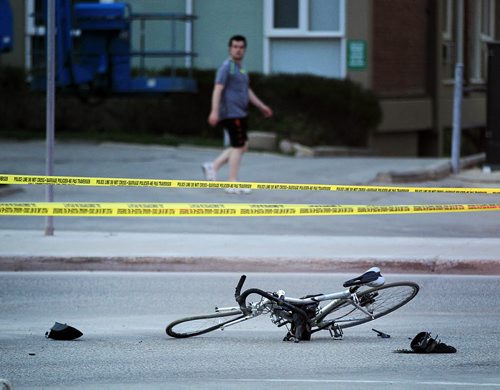 PHIL HOSSACK / WINNIPEG FREE PRESS -  A pedestrian walks by the cene of a car cyclist accident at Wellington and Grosvenor Wednesday night. May 18, 2016