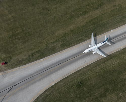DAVID LIPNOWSKI / WINNIPEG FREE PRESS  Westjet Airplane at Winnipeg James Armstrong Richardson International Airport  Aerial photography over Winnipeg May 18, 2016 shot from STARS helicopter.