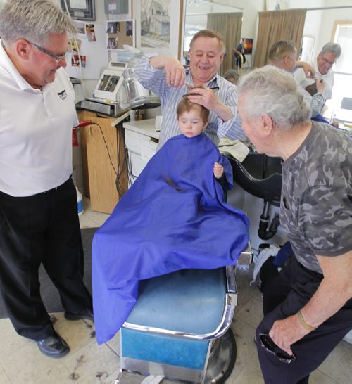 BORIS MINKEVICH / WINNIPEG FREE PRESS (centre) Barber Rocky Curatola of Rocky's Men's Hair Styling cuts a fifth generation customer Lincoln Alto, just shy of 2 years old, while grandpa (left) Dr. Lauri Alto, 61, and great grandpa (right) Olie Alto, 87, watch on. This is the boys 3rd haircut. The boys dad couldn't make it down for the photo because of work, but grandpa and great gramps were happy to help pass down the family tradition. Great Great Grandfather Lauri Alto passed away. Photo taken at the barber shop's current location at 290 Pembina Highway. May 19, 2016.