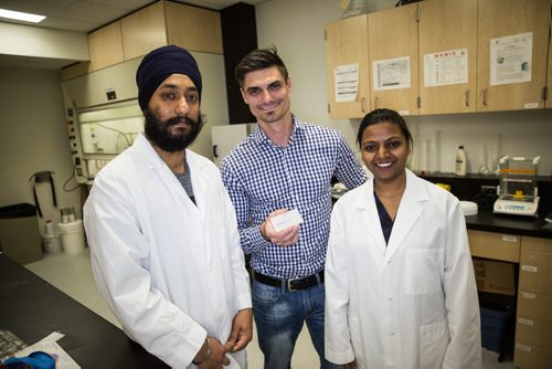 MIKE DEAL / WINNIPEG FREE PRESS Zach Wolff the CEO of Exigence Technologies (centre) and two of his scientists Dr. Gurmeet Sing Bindra (left) and Dr. Harshita Chaudhary (right). Exigence Technologies is a Winnipeg company that has a novel antimicrobial technology that is on the verge of cracking into some significant commercial markets. 160519 - Thursday, May 19, 2016