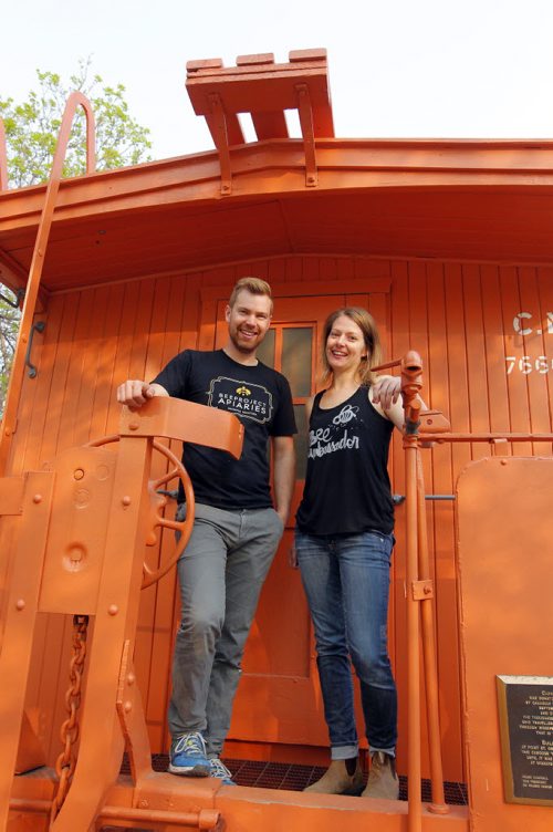 BORIS MINKEVICH / WINNIPEG FREE PRESS Buzzing with Excitement at The Forks  Over Launch of Urban Bee Project. Chris Kirouac and Lindsay Nikkel of BeeProject Apiaries pose for a photo on the train car that the bee hives are mounted on. In partnership with BeeProject Apiaries, two honey beehives will be installed on top of the Caboose at The Forks. May 20, 2016.
