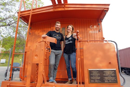 BORIS MINKEVICH / WINNIPEG FREE PRESS Buzzing with Excitement at The Forks  Over Launch of Urban Bee Project. Chris Kirouac and Lindsay Nikkel of BeeProject Apiaries pose for a photo on the train car that the bee hives are mounted on. In partnership with BeeProject Apiaries, two honey beehives will be installed on top of the Caboose at The Forks. May 20, 2016.