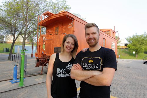 BORIS MINKEVICH / WINNIPEG FREE PRESS Buzzing with Excitement at The Forks  Over Launch of Urban Bee Project. Lindsay Nikkel and Chris Kirouac of BeeProject Apiaries pose for a photo in front of the train car that the bee hives are mounted on. In partnership with BeeProject Apiaries, two honey beehives will be installed on top of the Caboose at The Forks. May 20, 2016.