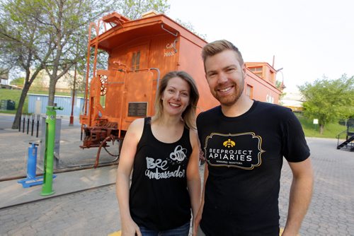 BORIS MINKEVICH / WINNIPEG FREE PRESS Buzzing with Excitement at The Forks  Over Launch of Urban Bee Project. Lindsay Nikkel and Chris Kirouac of BeeProject Apiaries pose for a photo in front of the train car that the bee hives are mounted on. In partnership with BeeProject Apiaries, two honey beehives will be installed on top of the Caboose at The Forks. May 20, 2016.