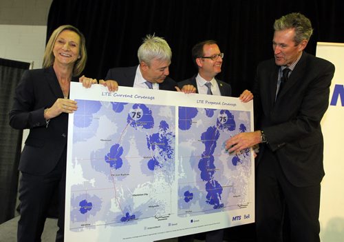 BORIS MINKEVICH / WINNIPEG FREE PRESS Official announcement of cell coverage improvements south of the city on highway 75. L-R  Patricia Solman (MTS), Wade Oosterman (Bell), Chris Goertzen (Association of Manitoba Municipalities), and Premier Brian Pallister. They pose with the before and after map of cell coverage involved. May 20, 2016.
