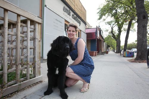 RUTH BONNEVILLE / WINNIPEG FREE PRESS  Threads: EMK clothing at 143 Sherbrook with owner Eron Kembel and her dog Marigold.  She models one of her designer dress - Nora Dress in blue polka dot, in front of her store with her dog.   Column is about local clothing designer Erin Kembel with EMK clothing features Mia & Moss cashmere denim jeans to compliment her tops and clothing line.     May 19, , 2016