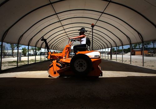RUTH BONNEVILLE / WINNIPEG FREE PRESS  Stacie Simonson with Meridian Landscaping, compacts the gravel prepping it for the seasonal opening of the St. Norbert Farmers Market that opens tomorrow and runs from 8am - 3pm. Standup photo   May 20, , 2016