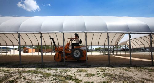 RUTH BONNEVILLE / WINNIPEG FREE PRESS  Stacie Simonson with Meridian Landscaping, compacts the gravel prepping it for the seasonal opening of the St. Norbert Farmers Market that opens tomorrow and runs from 8am - 3pm. Standup photo   May 20, , 2016