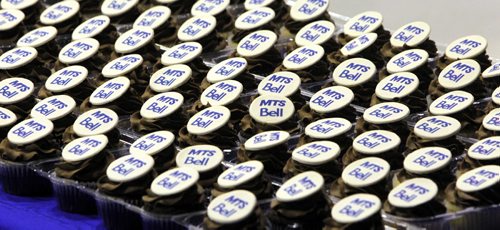 BORIS MINKEVICH / WINNIPEG FREE PRESS Official announcement of cell coverage improvements south of the city on highway 75. Cupcakes with both logos on it. May 20, 2016.