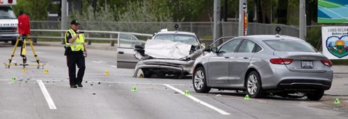 WAYNE GLOWACKI / WINNIPEG FREE PRESS   Winnipeg Police investigate the crash scene on McPhillips Street at Redwood Monday morning. The early morning incident involved at least two vehicles and closed both north and south bound lanes of McPhillips St.   May 23   2016