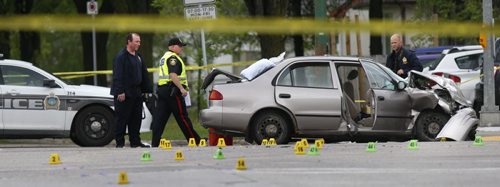 WAYNE GLOWACKI / WINNIPEG FREE PRESS   Winnipeg Police investigate the crash scene on McPhillips Street at Redwood Monday morning. The early morning incident involved at least two vehicles and closed both north and south bound lanes of McPhillips St.   May 23   2016