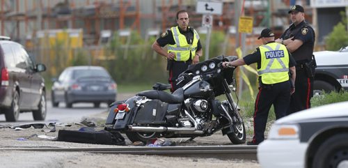 WAYNE GLOWACKI / WINNIPEG FREE PRESS    Winnipeg Police at the scene of a motorcycle crash¤Tuesday morning¤at the rail crossing on Archibald St. near Messier St.¤ May 24   2016