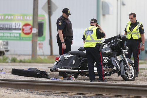 WAYNE GLOWACKI / WINNIPEG FREE PRESS    Winnipeg Police at the scene of a motorcycle crash¤Tuesday morning¤at the rail crossing on Archibald St. near Messier St.¤ May 24   2016