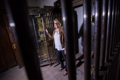 MIKE DEAL / WINNIPEG FREE PRESS The Millennium Centre at 389 Main Street is a heritage building located in the Exchange District. It is the previous home of the Canadian Imperial Bank of Commerce and is now used as an event venue. Cindy Tugwell, Executive Director for Heritage Winnipeg, in the vault in the basement of the Millennium Centre that would have held bank customers safety deposit boxes. 160510 - Tuesday, May 10, 2016