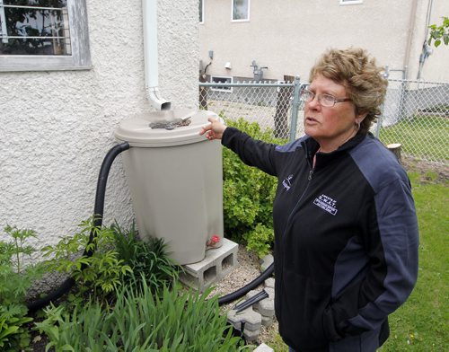 BORIS MINKEVICH / WINNIPEG FREE PRESS Ken Nawolsky, superintendent of insect control (not in photo)  launches Agents of S.W.A.T.(Standing Water Action Team) in a Transcona back yard owned by Louise Bohm. Bohm is photographed with stuff she keeps in mosquito breeding free state. May 24, 2016.