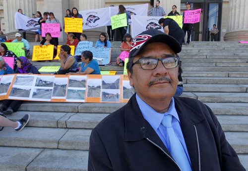 BORIS MINKEVICH / WINNIPEG FREE PRESS E. Gordon McGillivary, a health director at Split Lake, MB, and dozens of protesters at the Manitoba Legislature on Tuesday at 1:30 demand the new provincial government improve the road between Thompson and Gillam. May 24, 2016.