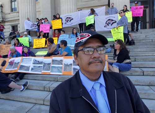 BORIS MINKEVICH / WINNIPEG FREE PRESS E. Gordon McGillivary, a health director at Split Lake, MB, and dozens of protesters at the Manitoba Legislature on Tuesday at 1:30 demand the new provincial government improve the road between Thompson and Gillam. May 24, 2016.