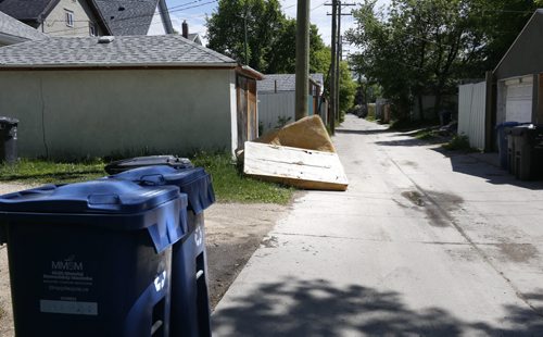 WAYNE GLOWACKI / WINNIPEG FREE PRESS   The back lane behind Boyd Ave. For city hall story on cameras being set up to capture people dumping junk. (The mattress may  have been put out by the home owner.) May 24   2016