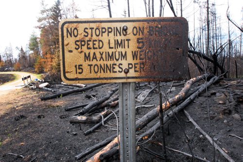 JOE BRYKSA / WINNIPEG FREE PRESS Burnt sign as seen leaving private 13 KM road from Nora and Florence Lake in the Whiteshell, May 24 , 2016.(see Nick Martin  story)