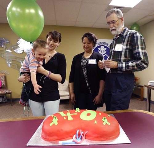 WAYNE GLOWACKI / WINNIPEG FREE PRESS   At right, Adrien Perras, a kidney transplant recipient celebrating his 40th anniversary of his transplant operation at the Kidney Foundation of Canada, Manitoba Branch Thursday that included a kidney shaped cake. He is with Stephanie Nelson who has had 2 kidney transplants and baked the cake, beisde Amy Wasicuna and her 2-year-old son Wyatt living with kidney disease. Ashley Prest story  May 26   2016