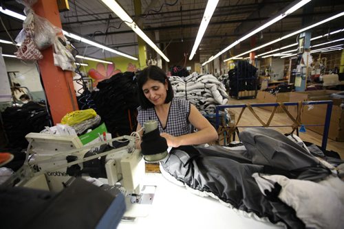 RUTH BONNEVILLE / WINNIPEG FREE PRESS  BIZ -  Sewing operator works on Moose Knuckles jacket at a manufacturing plant in Winnipeg.  For story on  outerwear manufacturer, Moose Knuckles,  facing sanctions from the Competition Bureau over alleged false "Made in Canada" claims.  Martin Cash story.    May 26,  2016