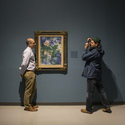 MIKE DEAL / WINNIPEG FREE PRESS Andrew Kear, Curator of Historical Canadian Art at the WAG is photographed by a member of the media in front of Marc Chagall's Flower Still Life, 1935, watercolour, gouache on paperboard on canvas. Kear was talking about the painting during a first look preview of three new exhibitions presented by the Winnipeg Art Gallery: Chagall:Daphnis & Chloé, Chagall & Winnipeg, and Esther Warkov: Paintings, 1960s-1980s. The shows open to the public Saturday, May 28 at 7:00pm with a free event.  160526 - Thursday, May 26, 2016