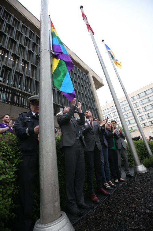 RUTH BONNEVILLE / WINNIPEG FREE PRESS  Winnipeg Mayor Brian Bowman and organizers with Pride Winnipeg, raise the rainbow flag on the opening day of the 29th Pride Winnipeg Festival at noon Friday at City Hall.    May 27,  2016