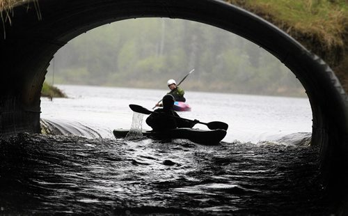PHIL HOSSACK / WINNIPEG FREE PRESS -  PHOTOSTORY -  Bradley Kulbaba drifts into "The Culvert" towards a set of standing waves at it's exit under a road east of Lac Du Bonnet. May 26, 2016