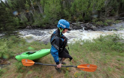 PHIL HOSSACK / WINNIPEG FREE PRESS -  PHOTOSTORY -   Steven Walker walks his boat past "The Wall" after deciding to avoid it on this trip in favor of better levels, he went on to  run other sections of "The Bird. May 26, 2016