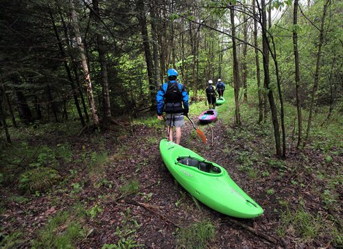 PHIL HOSSACK / WINNIPEG FREE PRESS -  PHOTOSTORY -  Left to right, Steven Walker, Lori Neufeld and Bradley Kulbaba walk dragging thier kayaks through the bush toward "The Canyon" as they prep to to run sections of "The Bird'. May 26, 2016