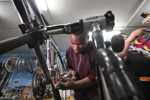 RUTH BONNEVILLE / WINNIPEG FREE PRESS  Isaiah Barhabaqua works on his bike at WRENCH  shop on Saturday located in  the basement of the City of Wpg Dog pound.  WRENCH was one of the shops open for visitors to tour during the annual Doors Open Winnipeg event Saturday.   See Carol Sanders story.   May 28,  2016